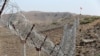 FILE - A view of the border fence outside the Kitton outpost on the border with Afghanistan in North Waziristan, Pakistan, Oct. 18, 2017. 