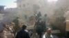 This photo provided by the Syrian Civil Defense White Helmets, which has been authenticated based on its contents and other AP reporting, shows Civil Defense workers and Syrian citizens inspecting damaged buildings after airstrikes hit in Darat Izza town, in rural western Aleppo province, Syria, Saturday, Nov. 5, 2016.