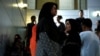 FILE - Relatives of victims of human trafficking wait for the sentence after an army general, two provincial politicians and police officers were among the 46 people held guilty in a court in Bangkok, Thailand, July 19, 2017.