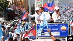 FILE - Opposition party Cambodia National Rescue Party officials greet their supporters from a truck as they lead a rally during the last day of campaigning ahead of communal elections in Phnom Penh, Cambodia, Friday, June 2, 2017. (AP Photo/Heng Sinith)