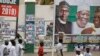 Un panneau d'affichage montrant le président du Nigeria Muhammadu Buhari et d'autres responsables du parti APC, à Kano, dans le nord du Nigeria, le 26 février 2019.