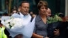 Australian Prime Minister Tony Abbott and his wife Margie prepare to place floral tributes near the cafe in central Sydney, December 16, 2014, where hostages were held for over 16-hours. 