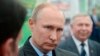 Russian President Vladimir Putin listens to employees of the Lukyanenko National Grain Center in Krasnodar, Russia, March 12, 2018. 