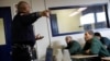 FILE - Inmates Marc Webb, 34, left, and Ivan Rodriguez, 55, listen to Corrections Officer Anthony Willingham during a training session at the Queensboro Correctional Facility in Queens, NY, April 9, 2018. 