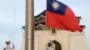 FILE - Two soldiers lower the national flag during the daily flag ceremony on Liberty Square of the Chiang Kai-shek Memorial Hall in Taipei, Taiwan, July 30, 2022. 