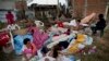 Four families wake up after sleeping outside their homes that collapsed during the earthquake in Manta, Ecuador, Tuesday, April 19, 2016. The strongest earthquake to hit Ecuador in decades flattened buildings and buckled highways along its Pacific coast, sending the Andean nation into a state of emergency. 