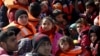 Refugees and migrants are seen on a dinghy as they approach the Ayios Efstratios Coast Guard vessel, during a rescue operation in the open sea between the Turkish coast and the Greek island of Lesbos, Feb. 8, 2016. 