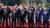 Chinese President Xi Jinping, front row third right, waves with leaders attending the Belt and Road Forum as they pose for a group photo at the Yanqi Lake venue on the outskirt of Beijing, China, Monday, May 15, 2017. They are, front row from left, Turkish President Recep Tayyip Erdogan, Vietnamese President Tran Dai Quang, Russian President Vladimir Putin, Xi, Indonesian President Joko "Jokowi" Widodo and Kazakhstan President Nursultan Nazarbayev, and second row from third left to right, Hungarian Prime Minister Viktor Orban, Cambodian Prime Minister Hun Sen, Spanish Prime Minister Mariano Rajoy, Malaysian Prime Minister Najib Razak and Ethiopian Prime Minister Hailemariam Desalegn. (AP Photo/Ng Han Guan, Pool)