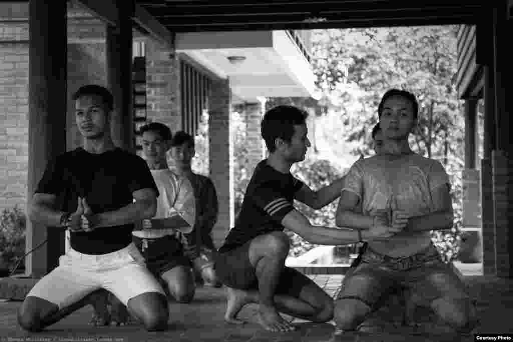 Choreographer Prumsodun Ok adjusts gestures and movements of his dancers during a rehearsal, Siem Reap, Cambodia, July 14, 2017. (Photo: Tom Whittaker)