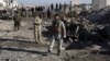 Afghan security personnel gather at the site of a suicide attack at a police compound in Maiwand district of Kandahar province on December 22, 2017.
