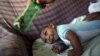 Jackeline, 26, uses a green bottle to stimulate to her son Daniel who is 4-months old and born with microcephaly, inside of their house in Olinda, near Recife, Brazil, Feb. 11, 2016. 