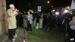 FILE - Members of a Muslim community say a prayer as they gather for a peaceful demonstration at Lakemba in suburban Sydney. 