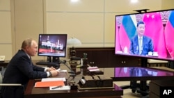 ប្រធានាធិបតី​រុស្ស៊ី Vladimir Putin ពិភាក្សា​ជាមួយ​ប្រធានាធិបតី​ចិន លោក Xi Jinping តាមរយៈ​សន្និសីទ​វីដេអូ​នៅឯ​គេហដ្ឋាន Novo-Ogaryovo នៅខាងក្រៅ​ទីក្រុង​មូស្គូ ប្រទេស​រុស្ស៊ី ថ្ងៃទី ១៥ ខែធ្នូ ឆ្នាំ ២០២១។ (AP)