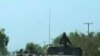 Thai military trucks with soldiers are driven to the Thai-Cambodia border for reinforcement in this still image taken from video April 22, 2011. Thai and Cambodian soldiers fought with rocket-propelled grenades and guns on their disputed border on Friday 