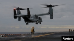 FILE - A U.S. Marines MV-22 Osprey Aircraft lands on the deck of the USS Bonhomme Richard amphibious assault ship off the coast of Sydney, Australia, June 29, 2017. 