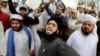 FILE - Pakistanis rally in support of Mumtaz Qadri who was convicted and executed for a blasphemy-motivated killing of a former governor, in Lahore, Pakistan, Feb. 29, 2016.