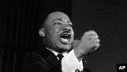 FILE - The Rev. Martin Luther King Jr. shakes his fist during a speech in Selma, Ala., Feb. 12, 1965.