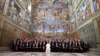 FILE - Pope Francis poses in the Sistine Chapel with members of the diplomatic corps accredited to the Holy See at the end of an audience for the traditional exchange of New Year greetings at the Vatican, Jan. 9, 2017.