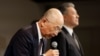 Daihatsu Motor President Soichiro Okudaira, flanked by Toyota Motor Executive Vice President Hiroki Nakajima, bows at the start of a news conference in Tokyo, Japan, Dec. 20, 2023. 