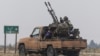 A rebel fighter sits on the back of a vehicle near Homs, Syria, after insurgents pressed their lightning advance on Dec. 7, 2024, saying they had seized most of the south, as government forces dug in to defend the key central city of Homs.