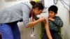 FILE - A boy gets an influenza vaccine injection at a health care clinic in Boston, Massachusetts, Jan. 12, 2013.