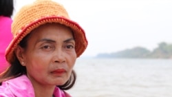 Phloak Sareth, 49, a villager from Kratie province's Sambor district, sits on a motorized boat along the Mekong River, March 11, 2020. (Sun Narin/VOA Khmer)