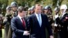 Turkish Prime Minister Ahmet Davutoglu, left, and his Australian counterpart Tony Abbott inspect a military honor guard during a welcome ceremony in Ankara, April 22, 2015.