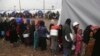 Displaced Iraqis, who fled fighting between Iraqi security forces and Islamic State militants, gather for food at a camp for internally displaced people in Hamam al-Alil, some 10 kilometers south of Mosul, Iraq, March 2, 2017.
