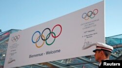 A Monaco policeman stands in front of the Grimaldi Forum during the opening of the 127th International Olympic Committee (IOC) session in Monaco, Dec. 8, 2014. 