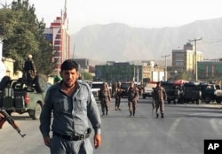 Description: Afghan security police stand guard near the site of a deadly suicide attack outside a cricket stadium, in Kabul, Afghanistan, Sept. 13, 2017.