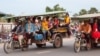 Garment factory workers leaves work on a packed tuk-tuk vehicle in the outskirt of Phnom Penh, Cambodia, May 25, 2017. (Khan Sokummono/VOA) 