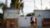 FILE - A man walks past the front gate of the International Committee of the Red Cross (ICRC) office in Jalalabad province, June 2, 2013