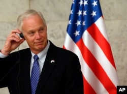 FILE - US Senator Ron Johnson listens Serbia's President Aleksandar Vucic in Belgrade, Serbia, Feb. 18, 2018.