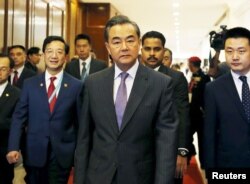 China's Foreign Minister Wang Yi arrives at a meeting during the 48th Association of Southeast Asian Nations (ASEAN) foreign ministers meeting in Kuala Lumpur, Malaysia, Aug. 4, 2015.