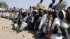 FILE - Internally displaced persons wait to be served with food at Dikwa camp, in northeast Nigeria's Borno state, Feb. 2, 2016.