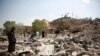 People gather as they inspect Youth and Sports Ministry's building destroyed by Saudi-led airstrikes in Sana'a, Yemen, Jan. 17, 2016. 