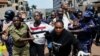 Ugandan police officers detain protestors during a rally against what the protesters say are rampant corruption and human rights abuses by the country's rulers in Kampala, Uganda, July 23, 2024. 