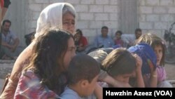 Familles victimes du conflit armé à Kobane, ville frontalière avec la Turquie, Syrie, 26 juin 2016.