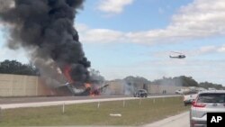 Smoke and fire fill the air after an airplane crashed on Interstate 75, Feb. 10, 2024, near Naples, Florida, killing two people. Federal authorities have launched an investigation to determine why the private jet tried to make an emergency landing on the highway.