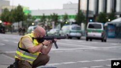 Des policiers déployés avec leurs armes prêts à tirer à l'extérieur du centre commercial Olympia à Munich, Allemagne du Sud, 22 juillet 2016. 