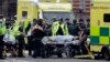 Emergency services transport an injured person to an ambulance, close to the Houses of Parliament in London, March 22, 2017.