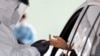 FILE - A woman's blood is collected for testing of coronavirus antibodies in Hempstead, N.Y., April 14, 2020. Doctors are seeking to grow antibodies and them against COVID-19.