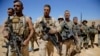 FILE - Lebanese soldiers listen to a briefing from an official during a media trip organized by the Lebanese army on the outskirts of Ras Baalbek, northeast Lebanon, Aug. 28, 2017.