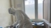 A member of medical staff wearing protective equipment, prepares to take care of patients amid the spread of the coronavirus disease (COVID-19), at an hospital in Douala, Cameroon, April 27, 2020.