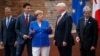 FILE - G-7 leaders, from left, President of the European Commission Jean-Claude Junker, Canadian Prime Minister Justin Trudeau, German Chancellor Angela Merkel, President Donald Trump, and Italian Prime Minister Paolo Gentiloni, pose for a family photo at the Ancient Greek Theater of Taormina, May 26, 2017, in Taormina, Italy. 