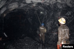 FILE - Workers are pictured at a mine in Bindura town, Zambia, Feb. 7, 2015.