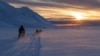 FILE - Scientists drive their snowmobiles cross the arctic towards Kongsfjord during sunset near Ny-Alesund, Svalbard, Norway, April 10, 2023. 