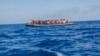 FILE - A rubber boat with 129 migrants on board, among them 60 women, is seen sailing out of control about 15 miles north of Al Khums, Libya, Aug. 1, 2017.