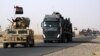 A convoy of Iraqi military vehicles heads toward Qayyarah base in northern Iraq, ahead of an expected offensive to retake Mosul from Islamic State militants, Oct. 15, 2016.
