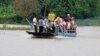 The coffin of Son Sophat, a teen victim of a boat accident, is carried in a wooden boat during a funeral procession in Koh Chamroeun village, east of Phnom Penh, Cambodia, Friday, Oct. 14, 2022.